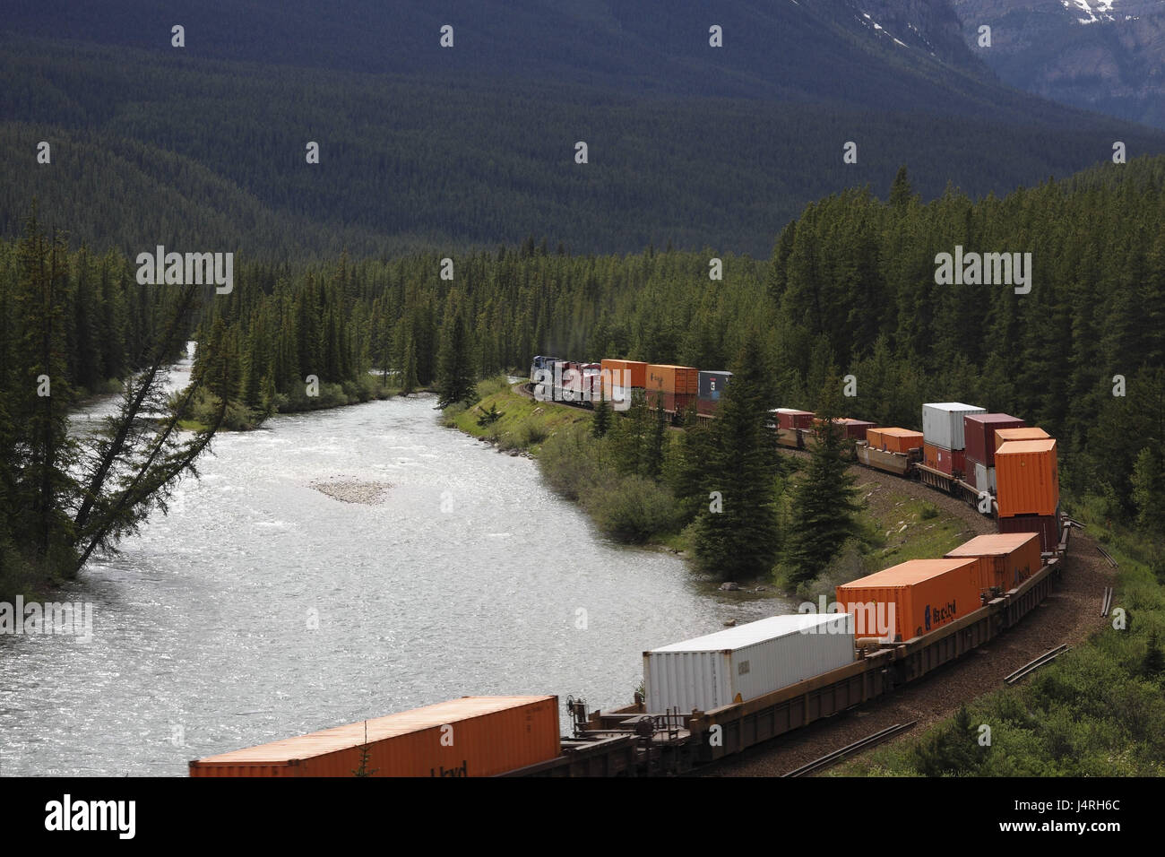 Goods train, Canadian Pacific Railway, river, tracks, sinuously, scenery, wooded, Canada, Alberta, Banff Nationwide park, Bow River, Stock Photo
