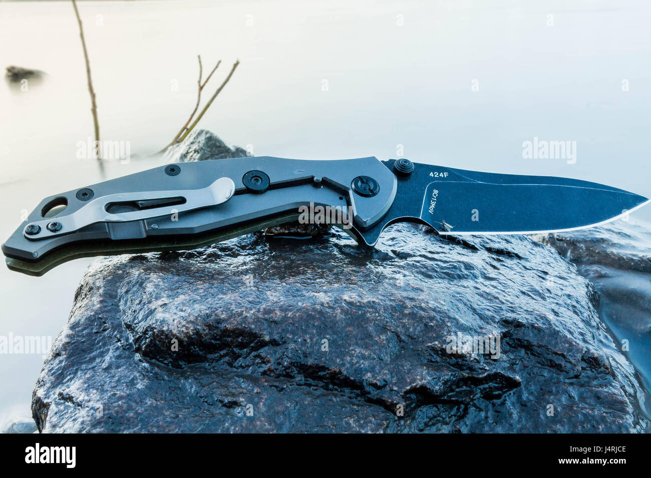 Pocket knife. Knife on wet stone. Folding knife Stock Photo Alamy