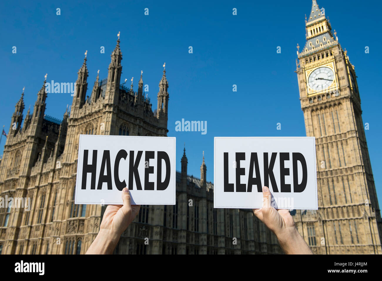 Signs representing issues with modern elections, the hacking of accounts and leaking of information, at the Houses of Parliament at Westminster London Stock Photo