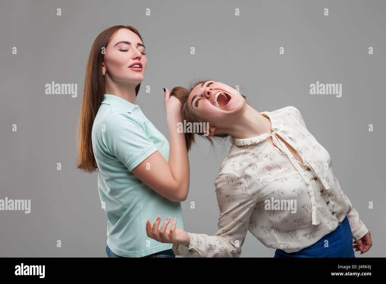 Two girls fighting women quarrel studio