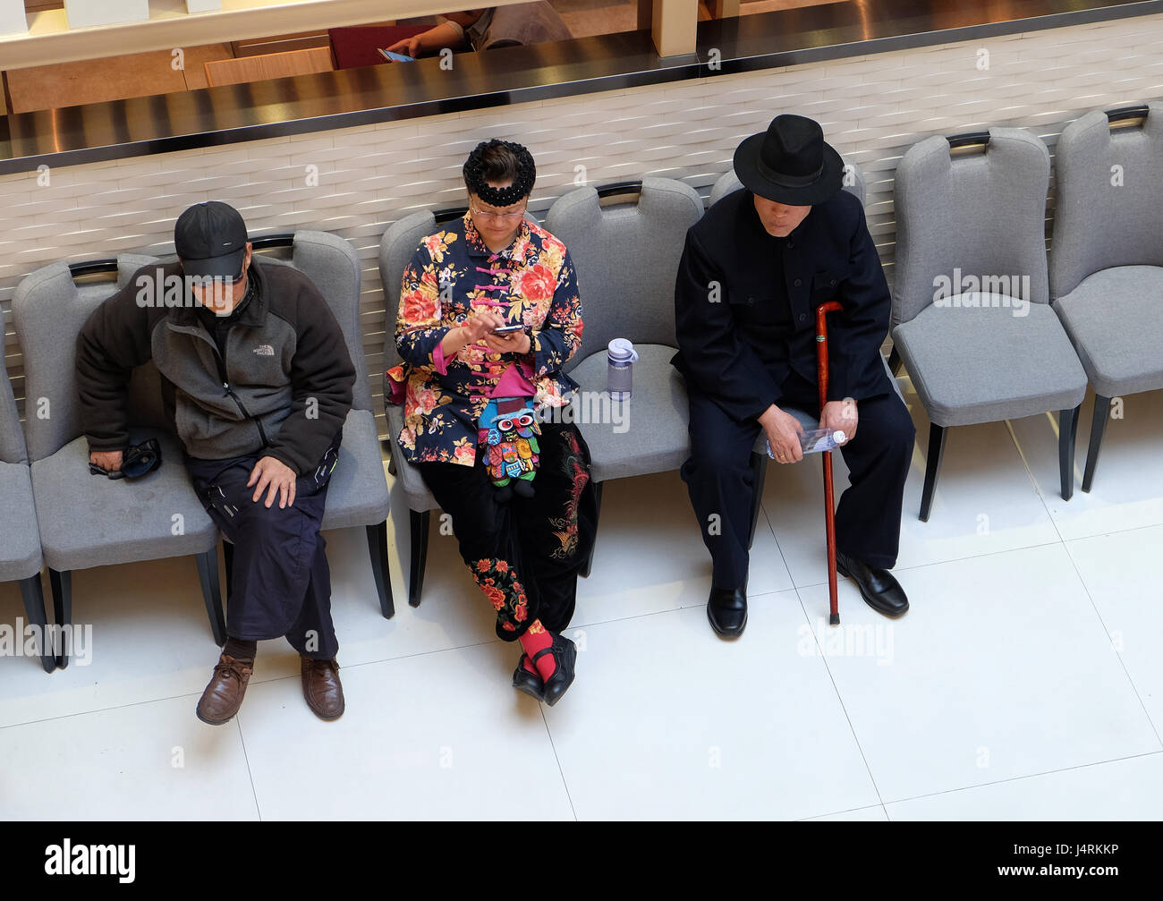 People resting in luxury shopping mall interior. Multi luxury brand and restaurants inside, in Shanghai, China Stock Photo