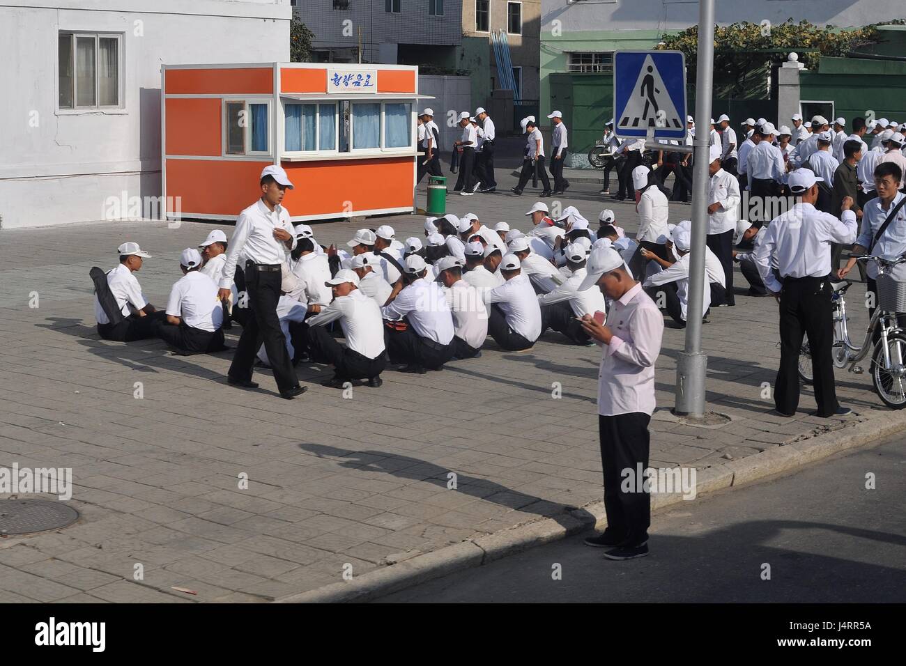 Schoolchildren awaiting parade rehearsal in Pyongyang, North Korea. Stock Photo