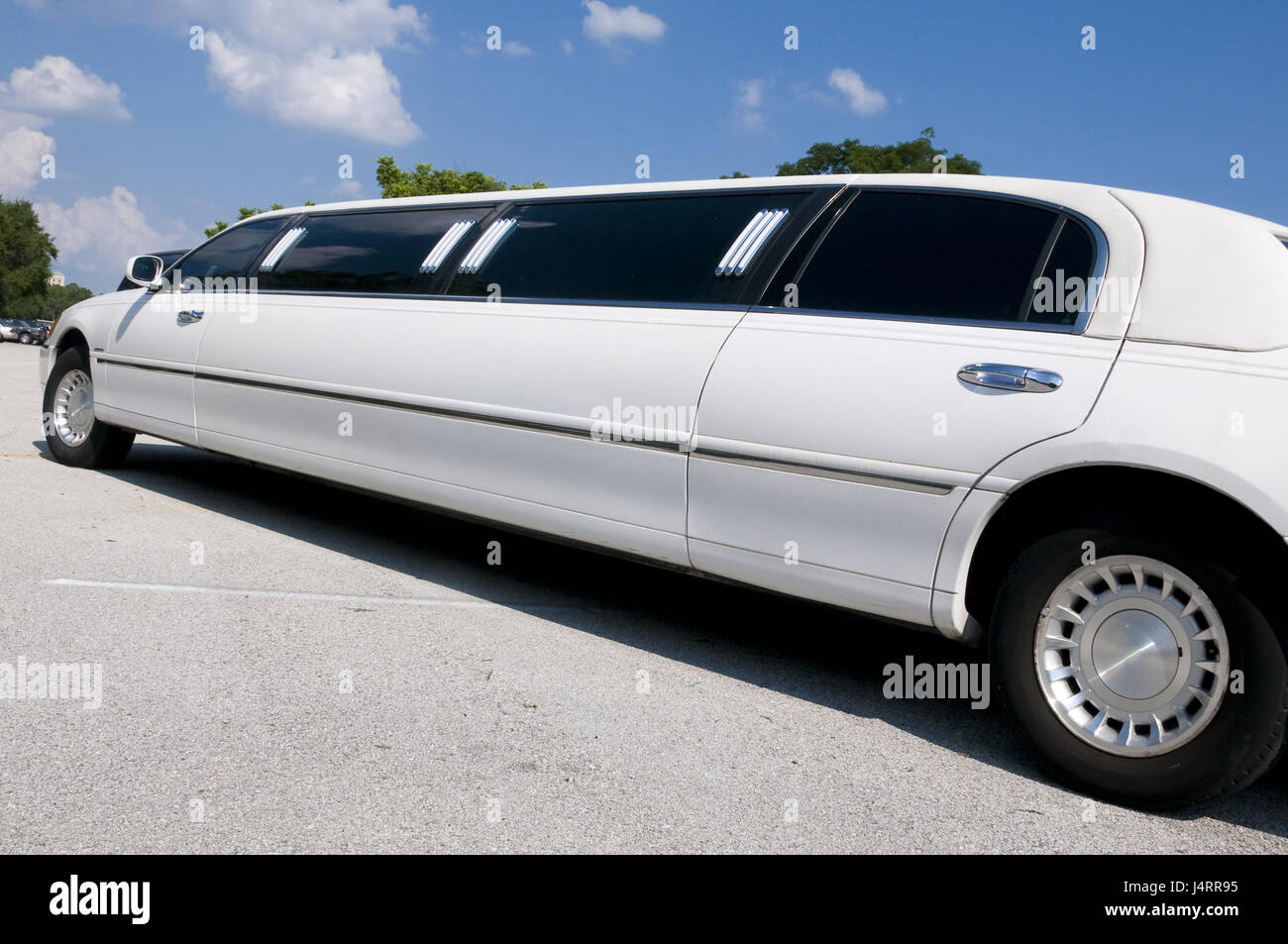 White Stretch limousine waiting for guests to arrive Stock Photo