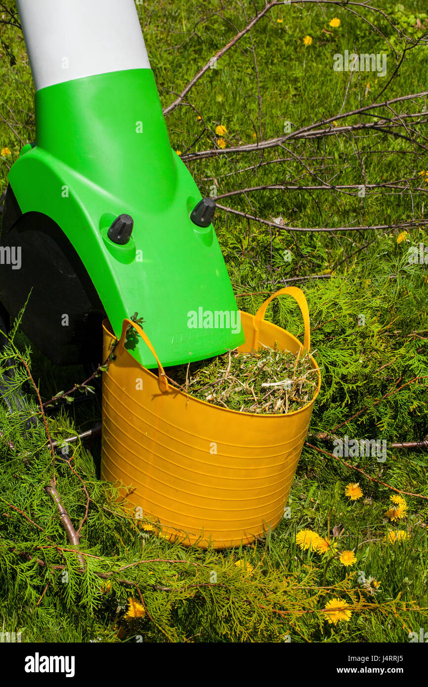 Electric garden shredder in a spring garden Stock Photo