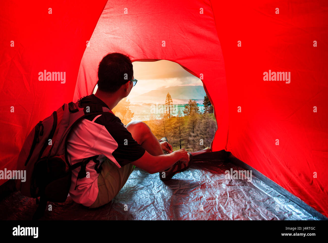 camping man in camper tent looking to beautiful natural scenic use for people vacation traveling to destination Stock Photo
