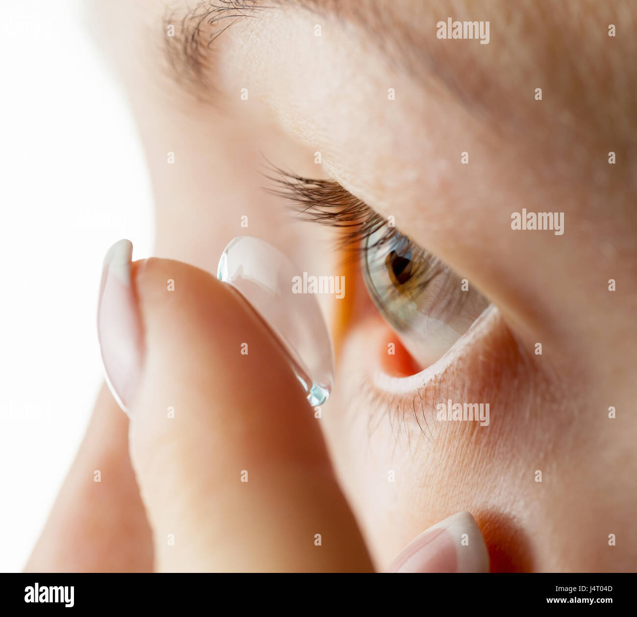 Woman inserts contact lenses. Focus on eyes Stock Photo