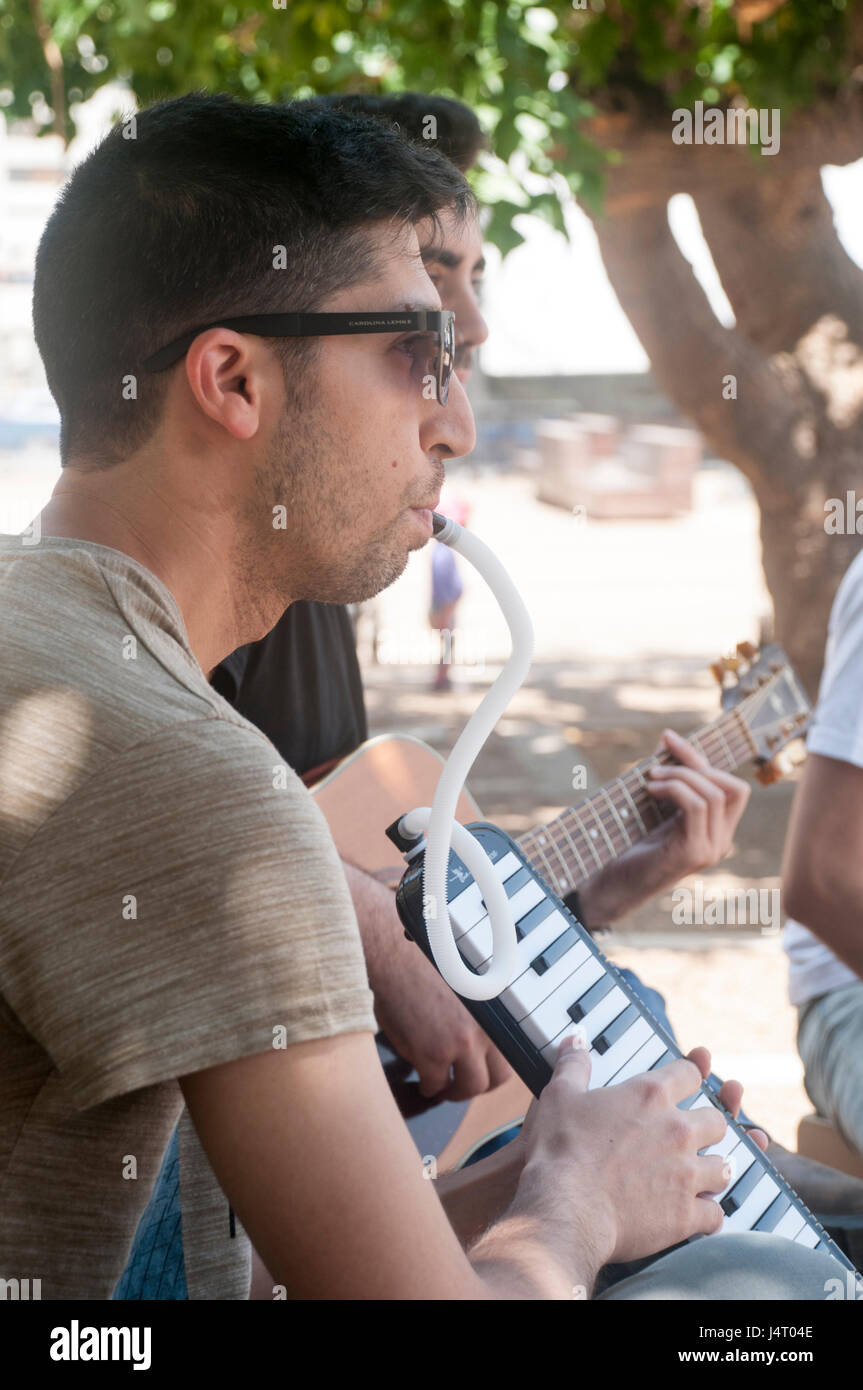 young man plays the Melodica outdoors Stock Photo Alamy
