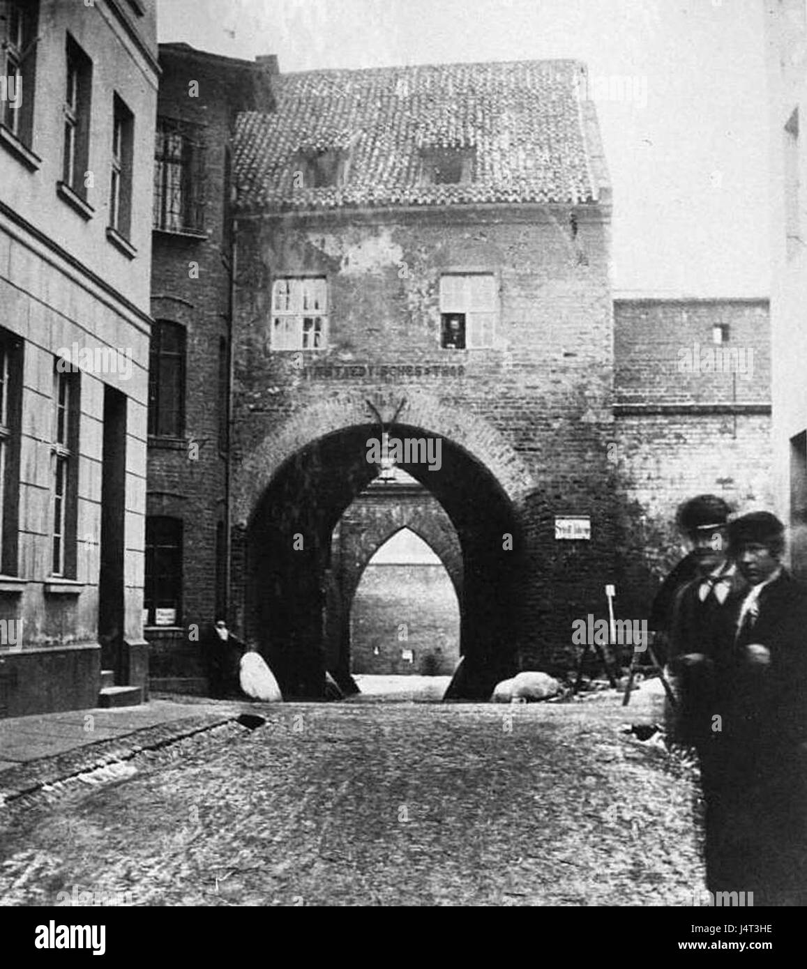 This translates to 'Torun, the Starotorunska Gate from the East.' Torun is a historical city in Poland, and the gate is an important architectural landmark. Stock Photo