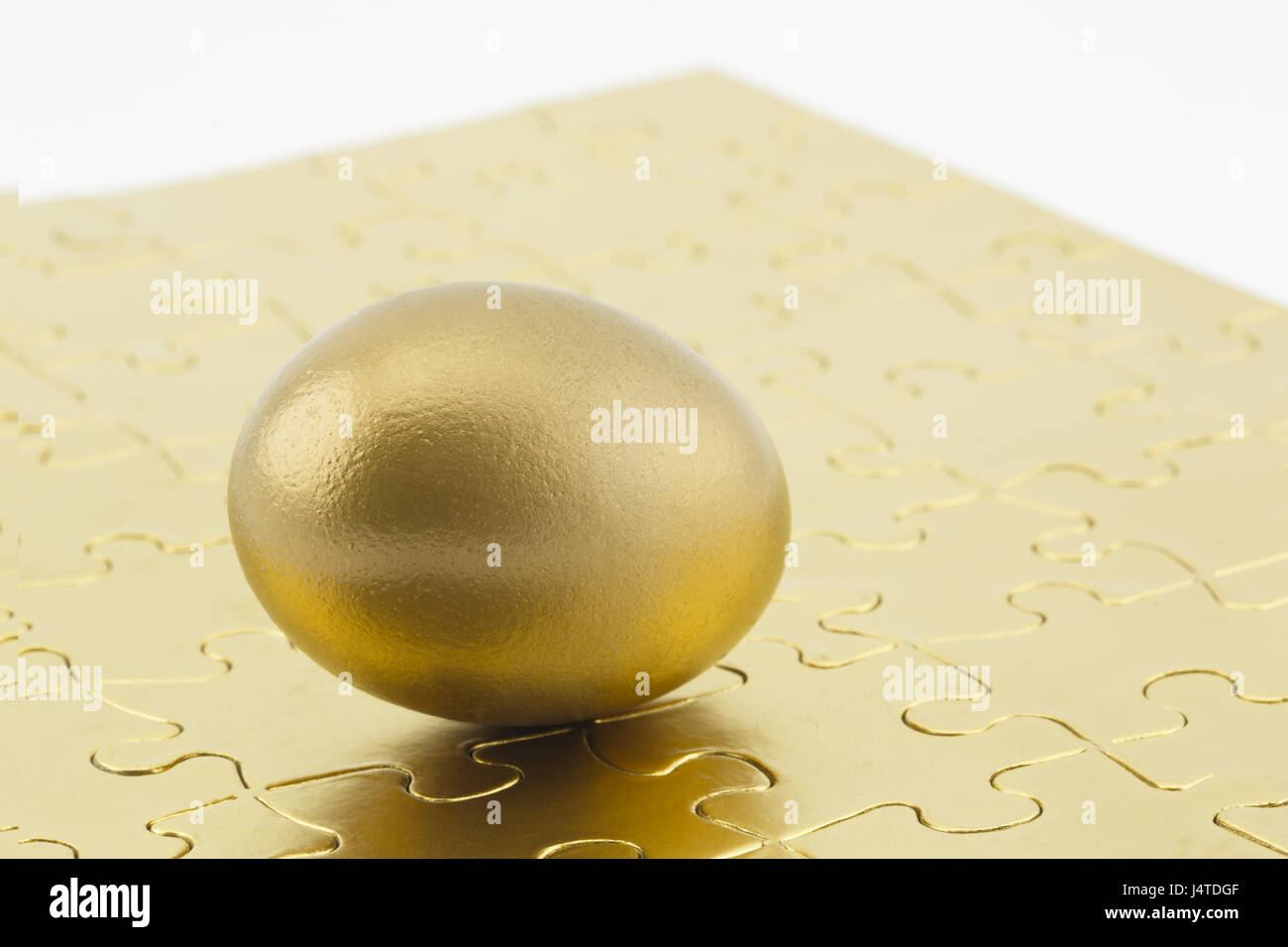 Gold egg at puzzle corner symbolizes successful solution Stock Photo