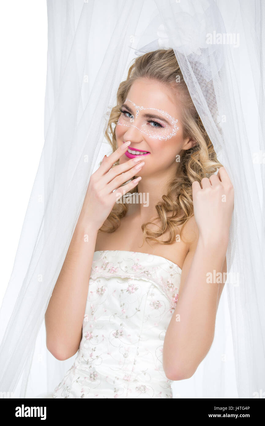 Bride with mask drawn on face Stock Photo