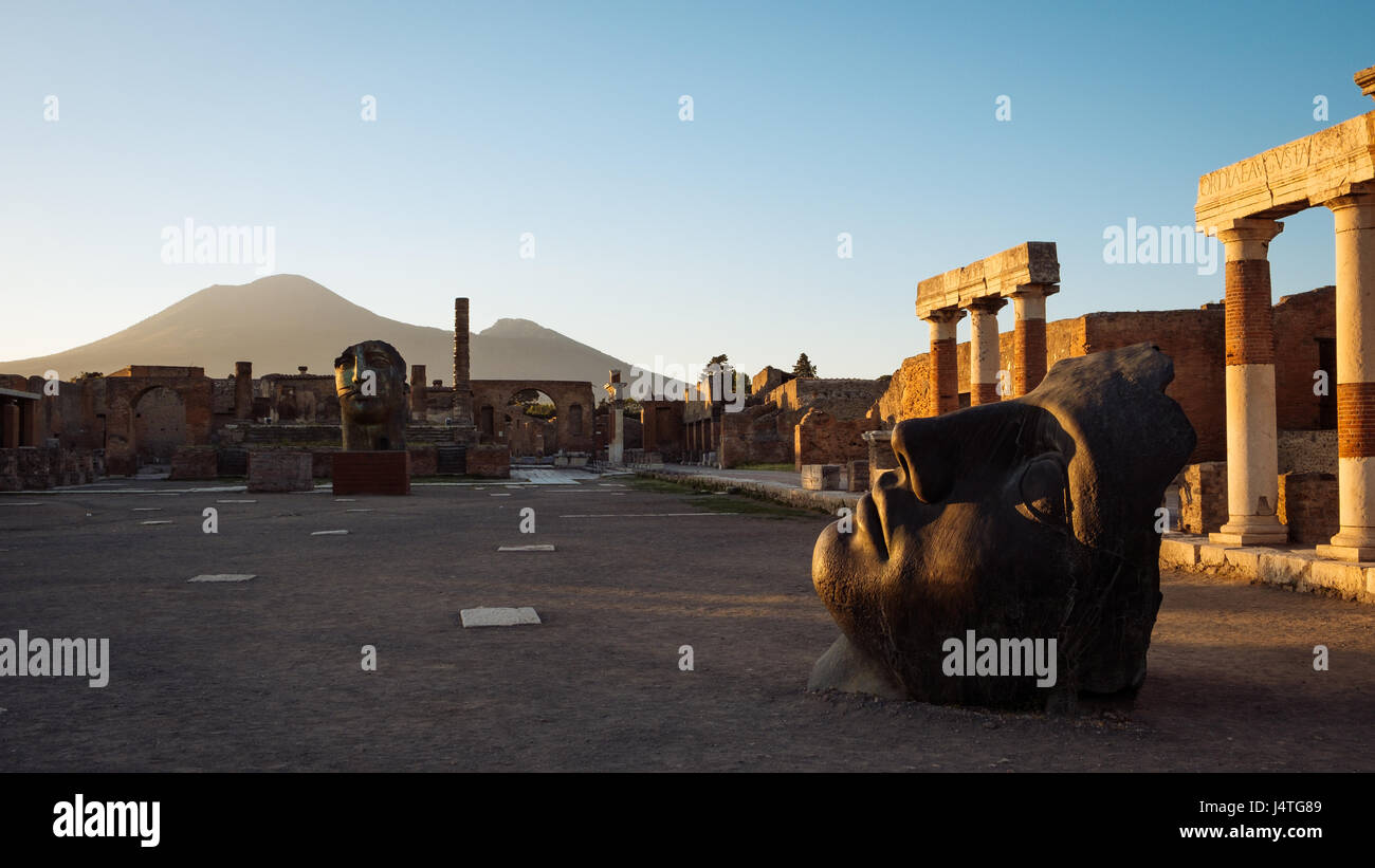 Scenic sunset view of ruins at ancient city of Pompeii with Vesuvio volcano background, Italy Stock Photo