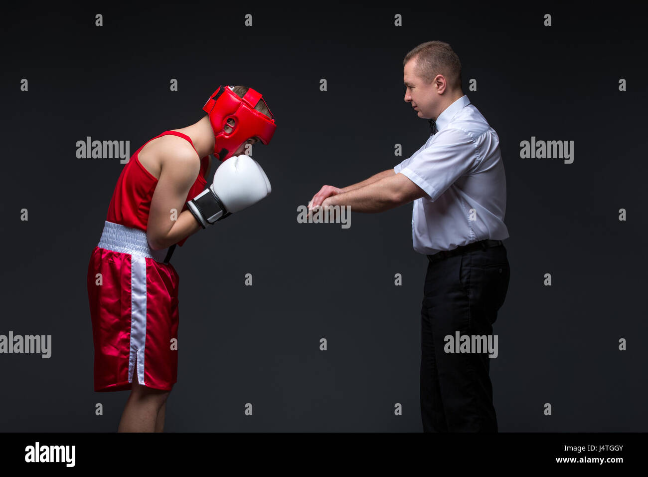 Referee checking young boxer Stock Photo Alamy