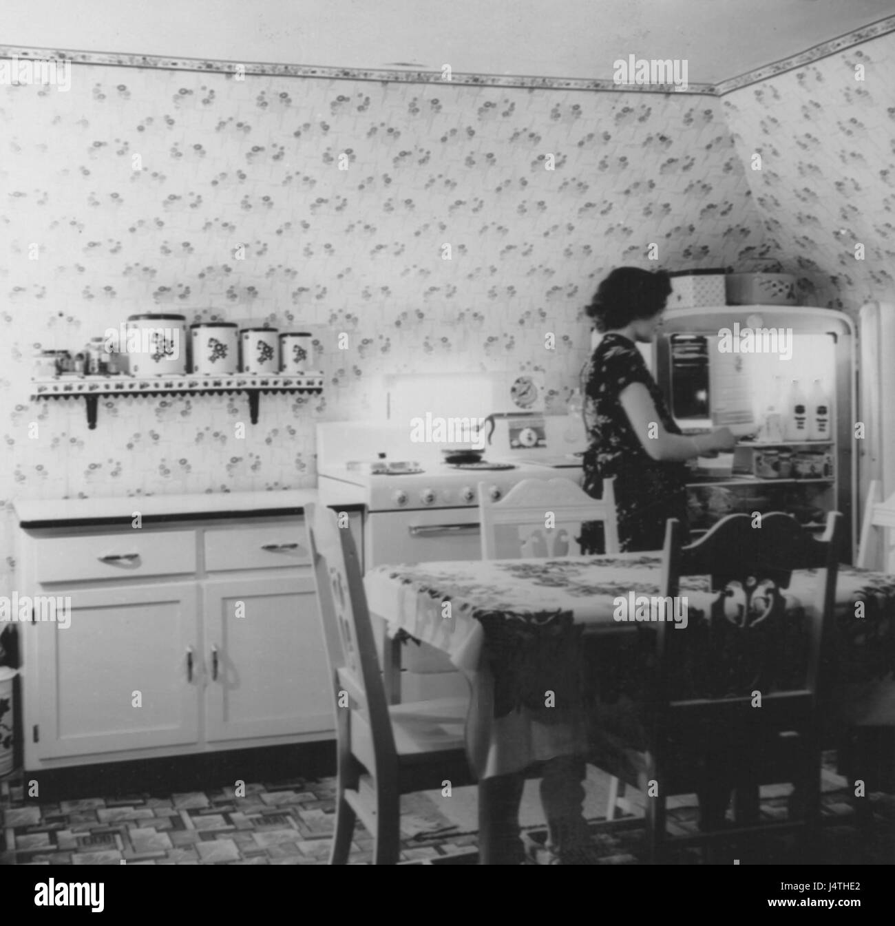 Housewife in Vintage Home Kitchen, 1940's, USA Stock Photo