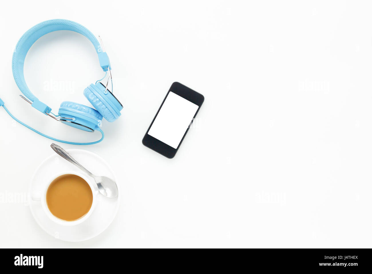 Top view  accessories office desk.smartphones headphones and cup of coffee on white background with copy space. Stock Photo