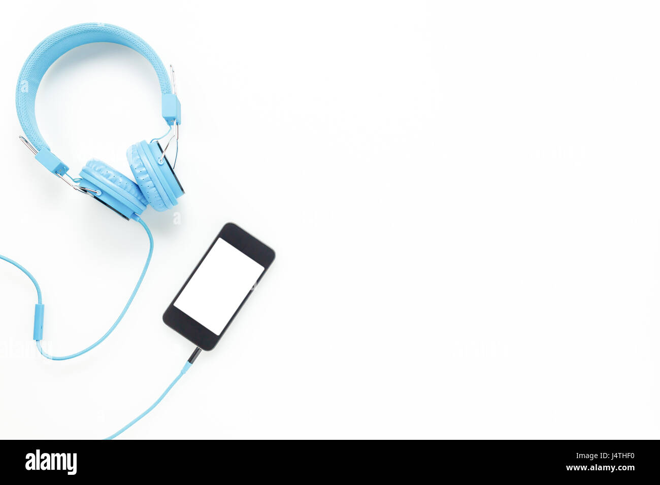 Top view  accessories office desk.smartphones headphones on white background with copy space. Stock Photo