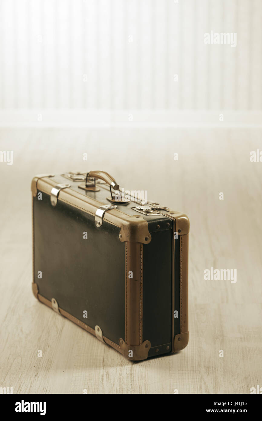 Oldfashioned suitcase alone in a room or station Stock Photo Alamy