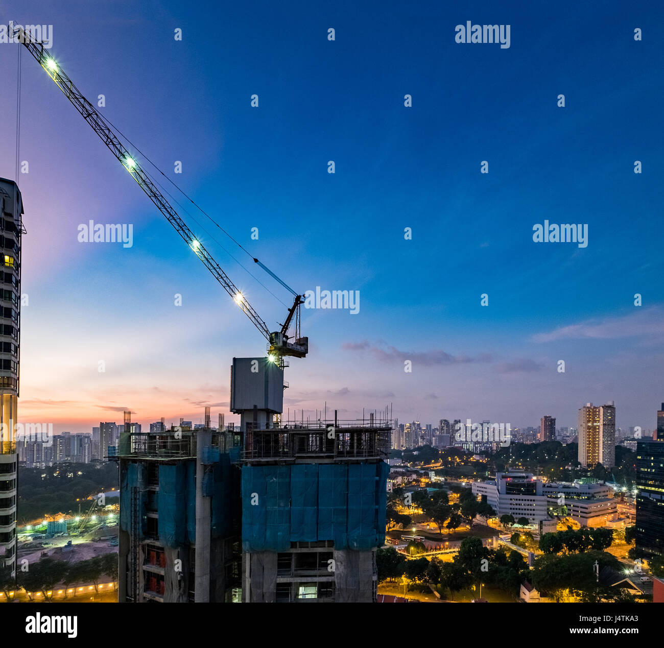 High rise living and construction at dusk in Singapore Stock Photo