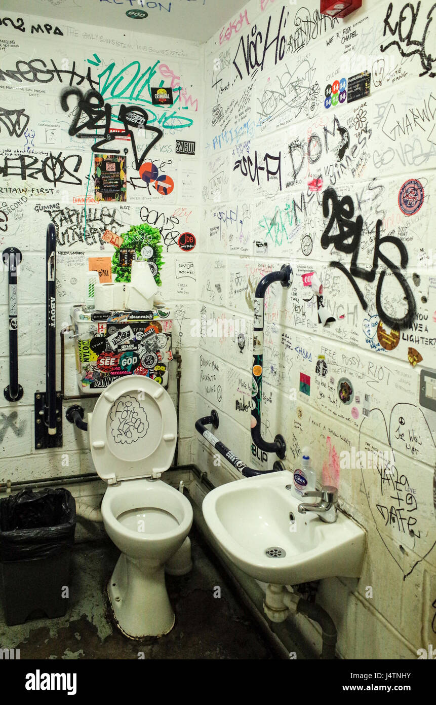 Graffiti decorated toilet cubicle at the Rough Trade East store off Brick Lane in East London Stock Photo