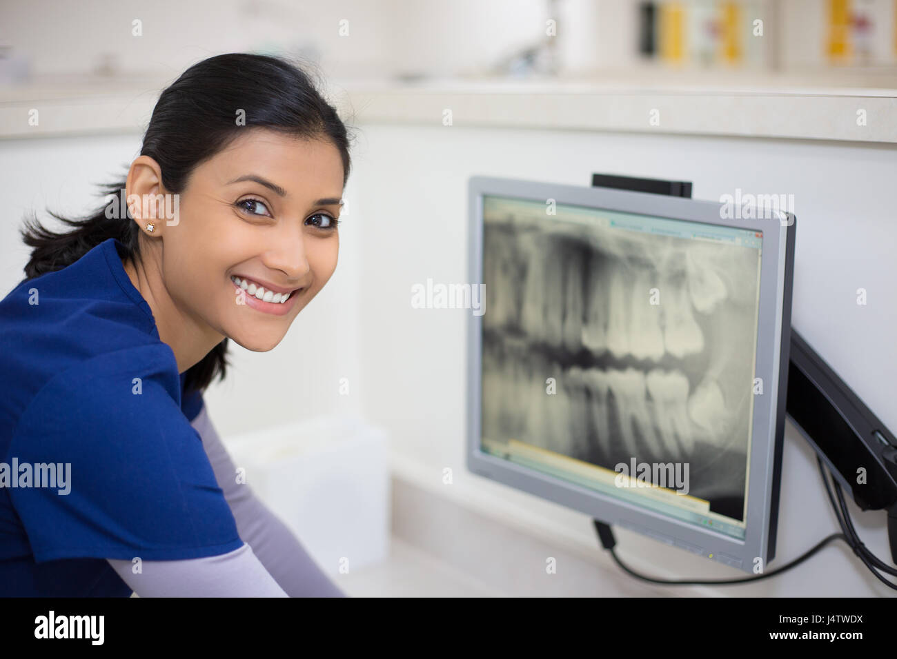 Closeup portrait of allied health dental professional in blue scrubs