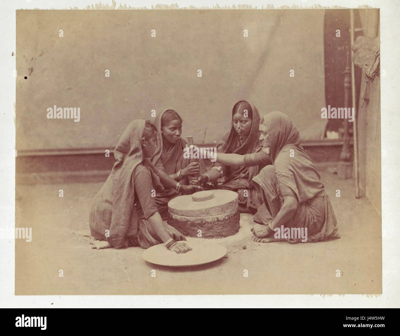 Women grinding corn Stock Photo Alamy