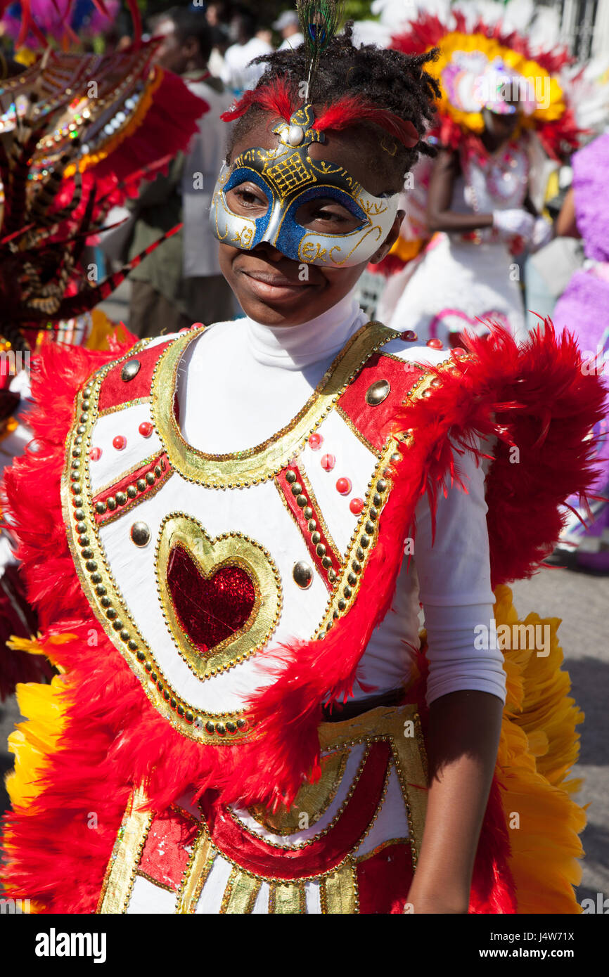 NASSAU, THE BAHAMAS - JANUARY 1 - Female dancer dressed in bright orange feathers and red hearts, dances in Junkanoo, a traditional island cultural fe Stock Photo
