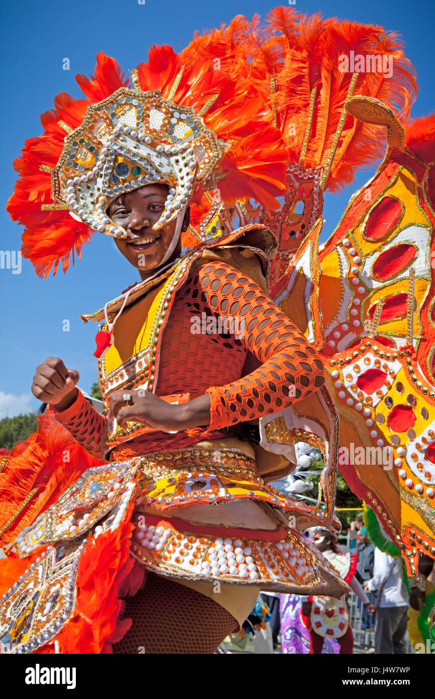 NASSAU, THE BAHAMAS - JANUARY 1 - Female troop leader dressed in bright orange feathers, dances in Junkanoo, a traditional island cultural festival in Stock Photo