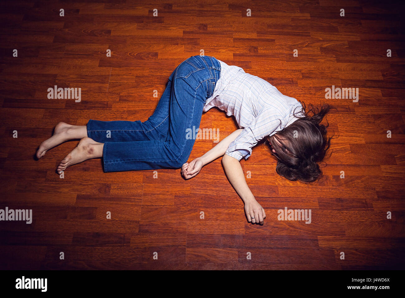 Girl lying on the floor in an empty room Stock Photo