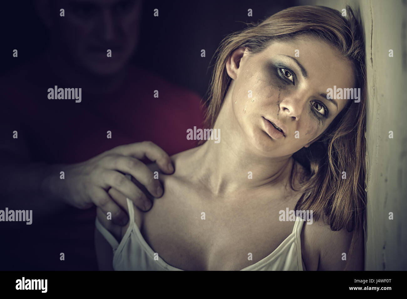Woman victim of domestic violence and abuse. Tears of a young woman Stock Photo