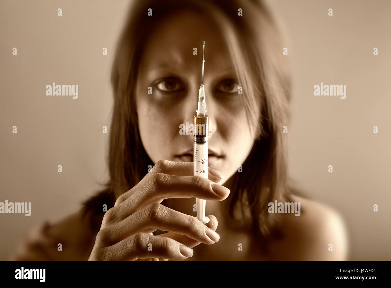 Young woman with drug addiction on dark background Stock Photo