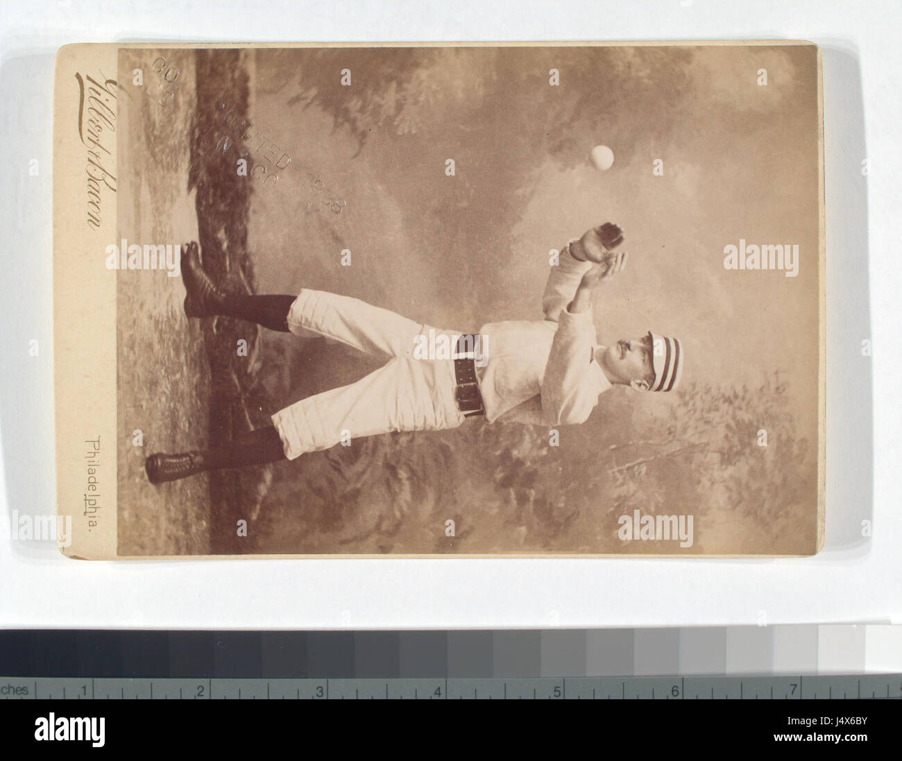 This image shows an unidentified baseball player in the catching ...