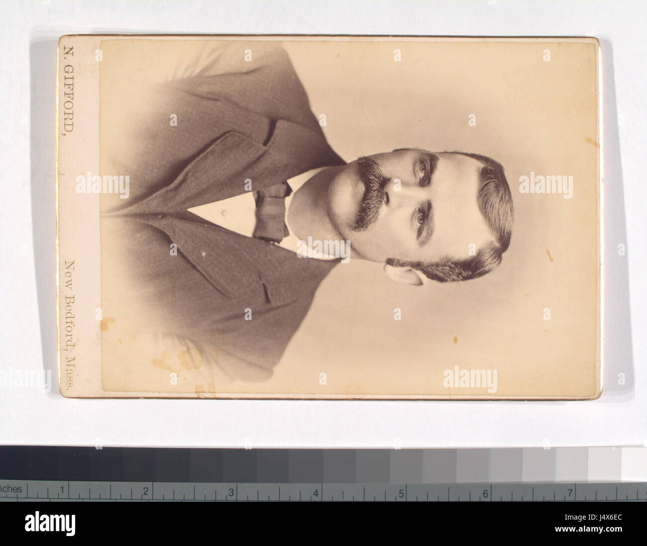 A vintage portrait of an unidentified man wearing a suit and bow tie ...