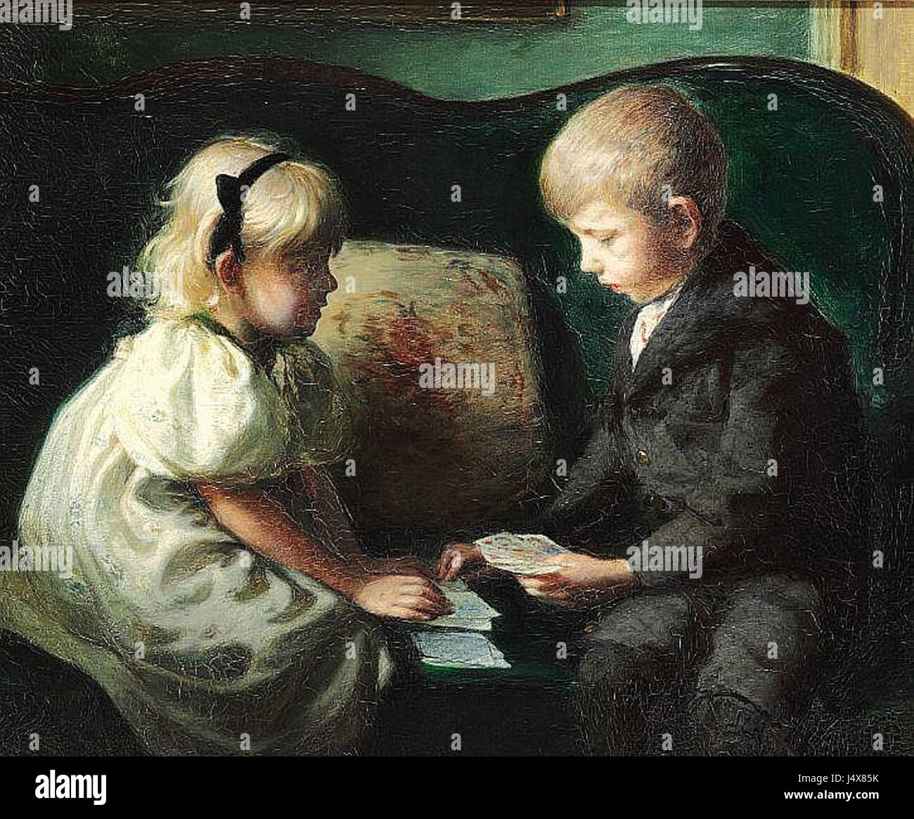 The silversmith and toy designer Kay Bojesen as a child playing cards with his sister Thyra Stock Photo