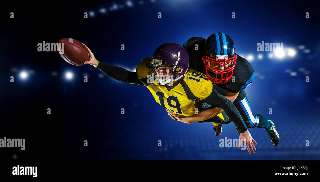 Two american football players fighting for ball. Mixed media Stock Photo