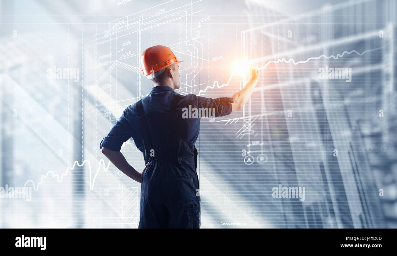 Engineer man standing with back and construction blueprints. Mixed ...