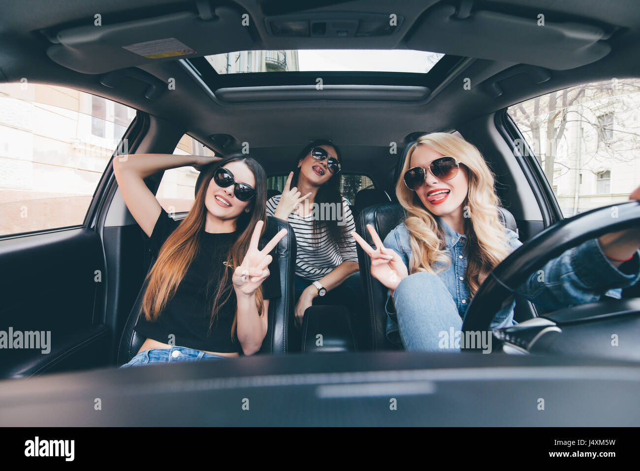 group-of-friends-having-fun-on-the-car-singing-and-laughing-in-the