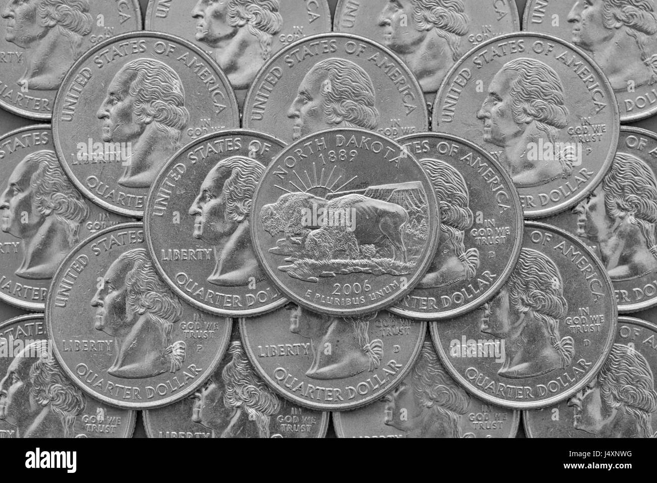 North Dakota State and coins of USA. Pile of the US quarter coins with George Washington and on the top a quarter of North Dakota State. Stock Photo