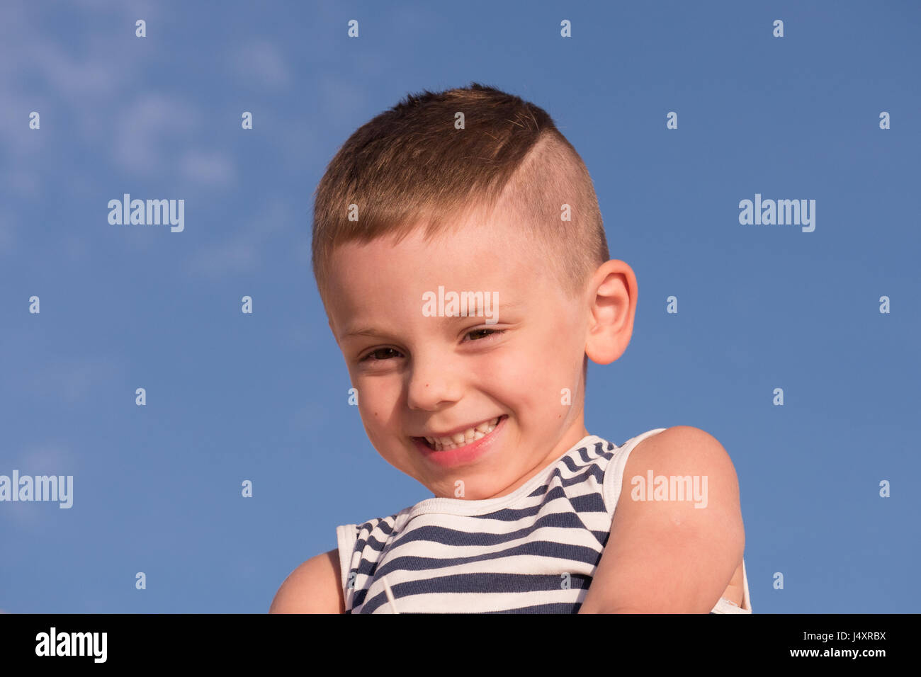 Happy Smiling Small Boy With Trendy Hairstyle Wearing Sailor