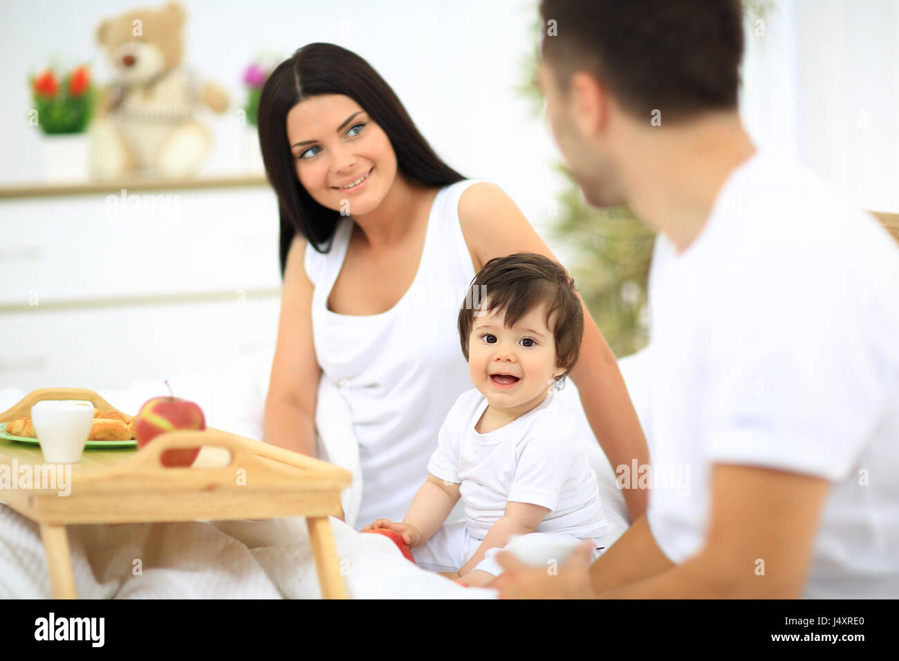 Smiling family having breakfast Stock Photo - Alamy