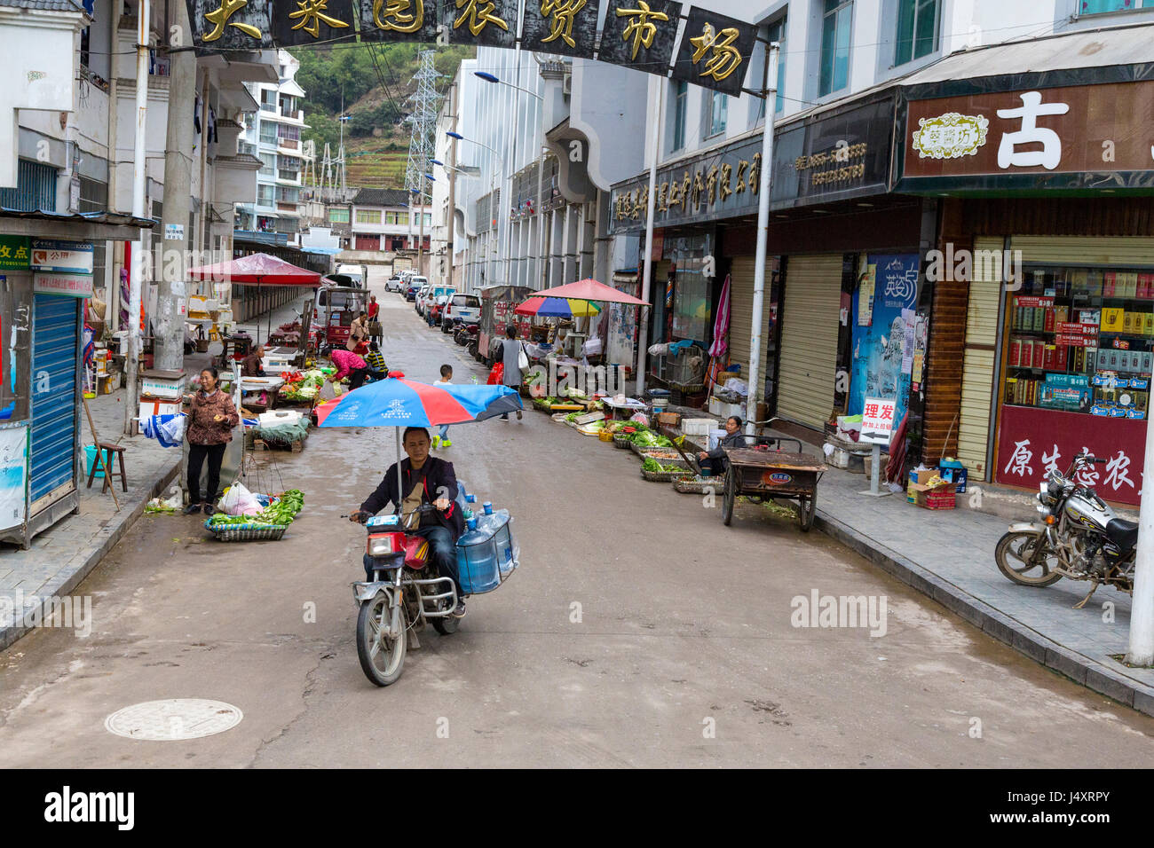 Zhenyuan, Guizhou, China.  Street Vendors Line the Sidewalk with their Wares. Stock Photo