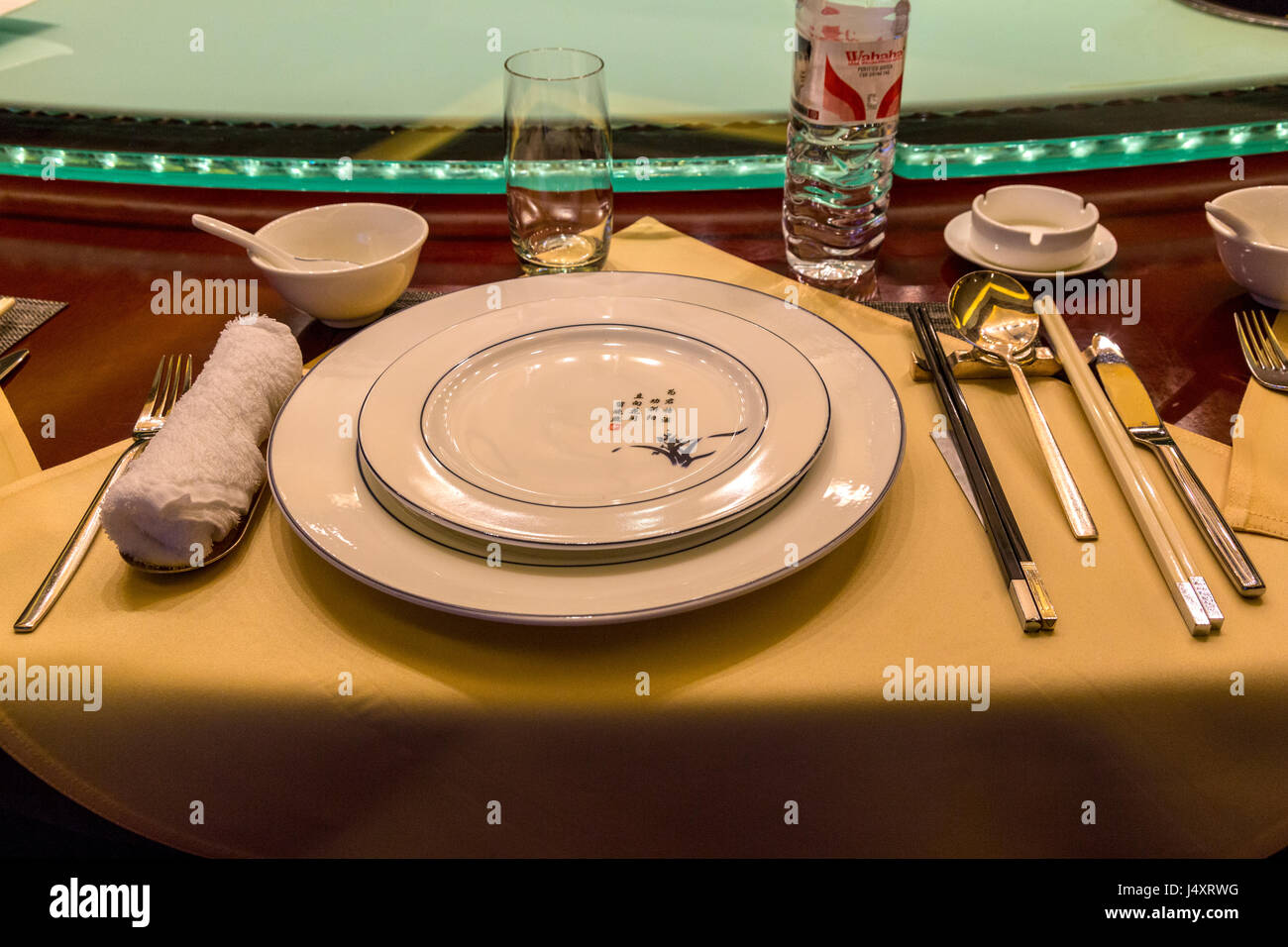China.  Chinese Table Place Setting with Chopsticks.  Lazy Susan (Rotating Serving Table) in background. Stock Photo