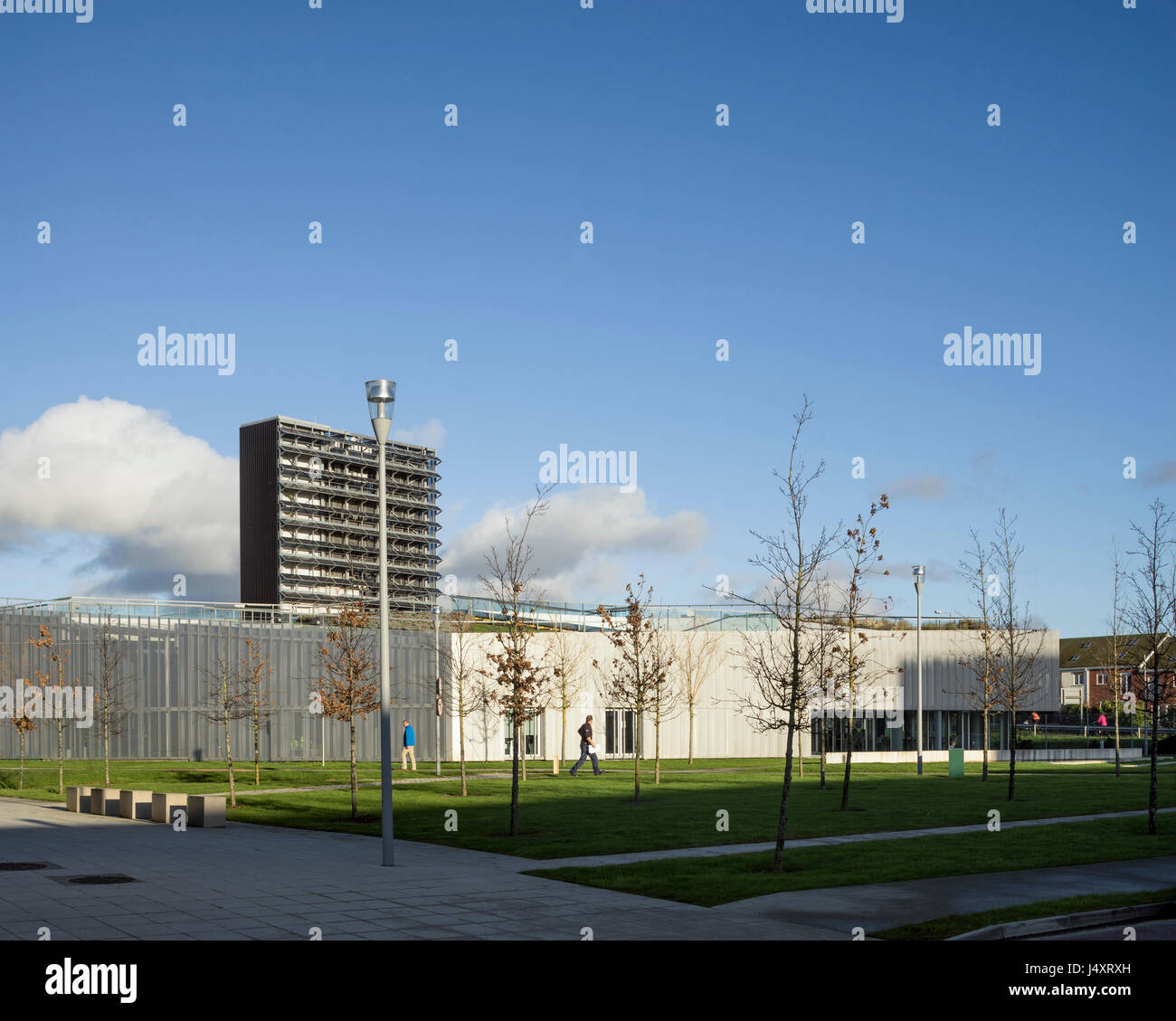 Distant view from landscaped approach towards building complex with ...