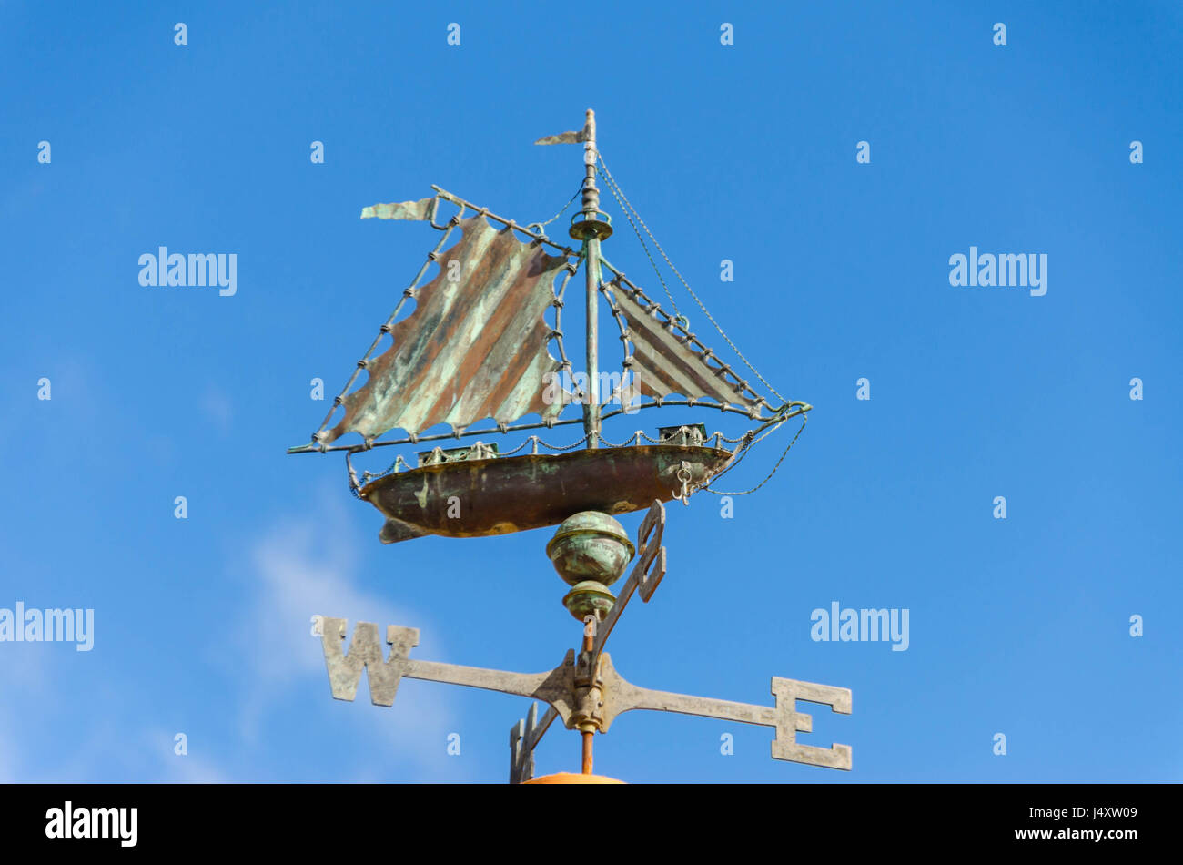 Saleboat Weather vane against blue sky Stock Photo