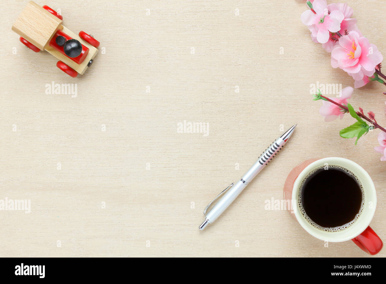 Top view business office desk background.The silver pen coffee beautiful pink flower toy car on wooden table backgtound with copy space. Stock Photo