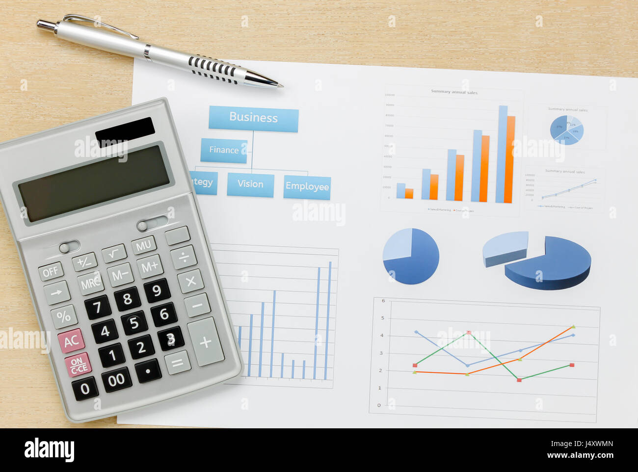 Top view business summary of the year and pen, chart calculator on wood  office desk background. Stock Photo