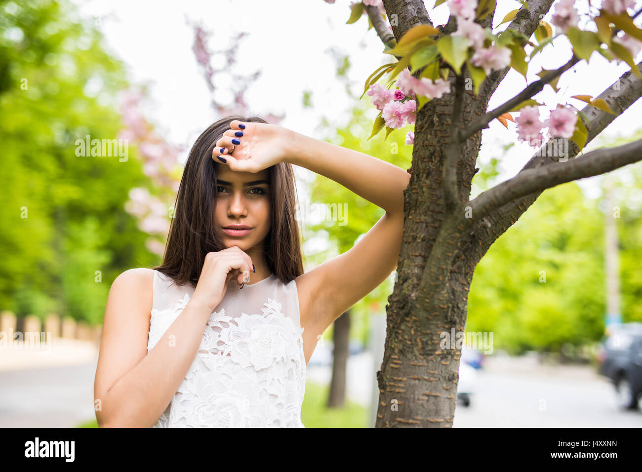 beautiful young woman in blooming cherry blossoms garden Stock Photo ...