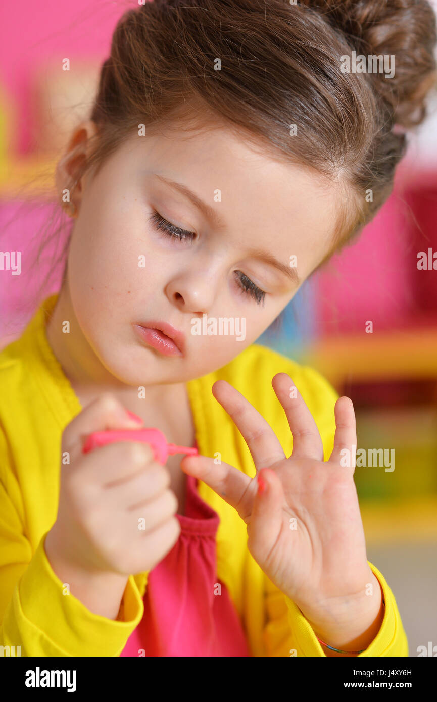 Beautiful girl paints her nails Stock Photo Alamy