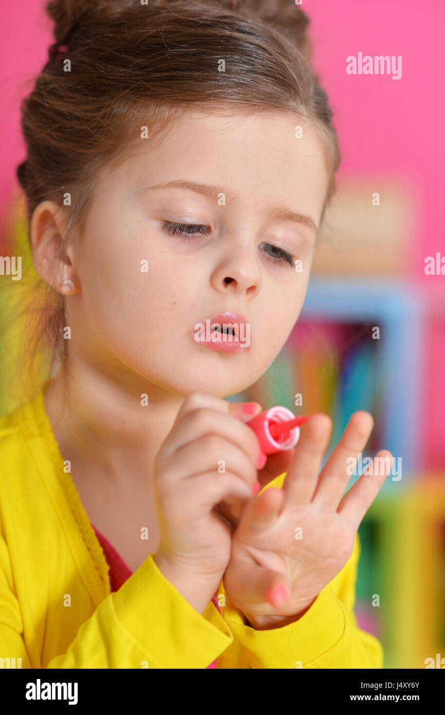 Beautiful girl paints her nails Stock Photo Alamy