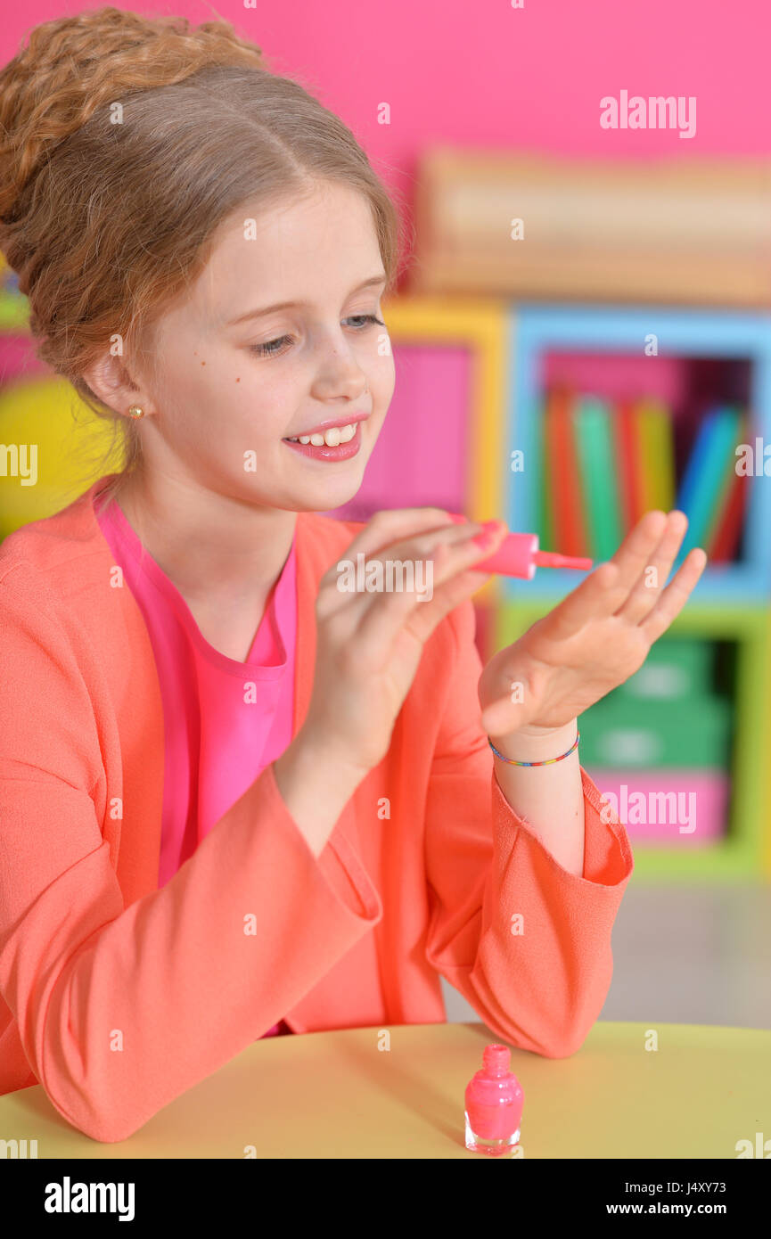 Beautiful girl paints her nails Stock Photo Alamy