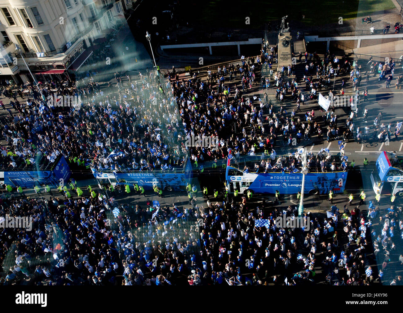 Brighton and Hove Albion football fans cheer their team during the bus parade through Brighton. Stock Photo
