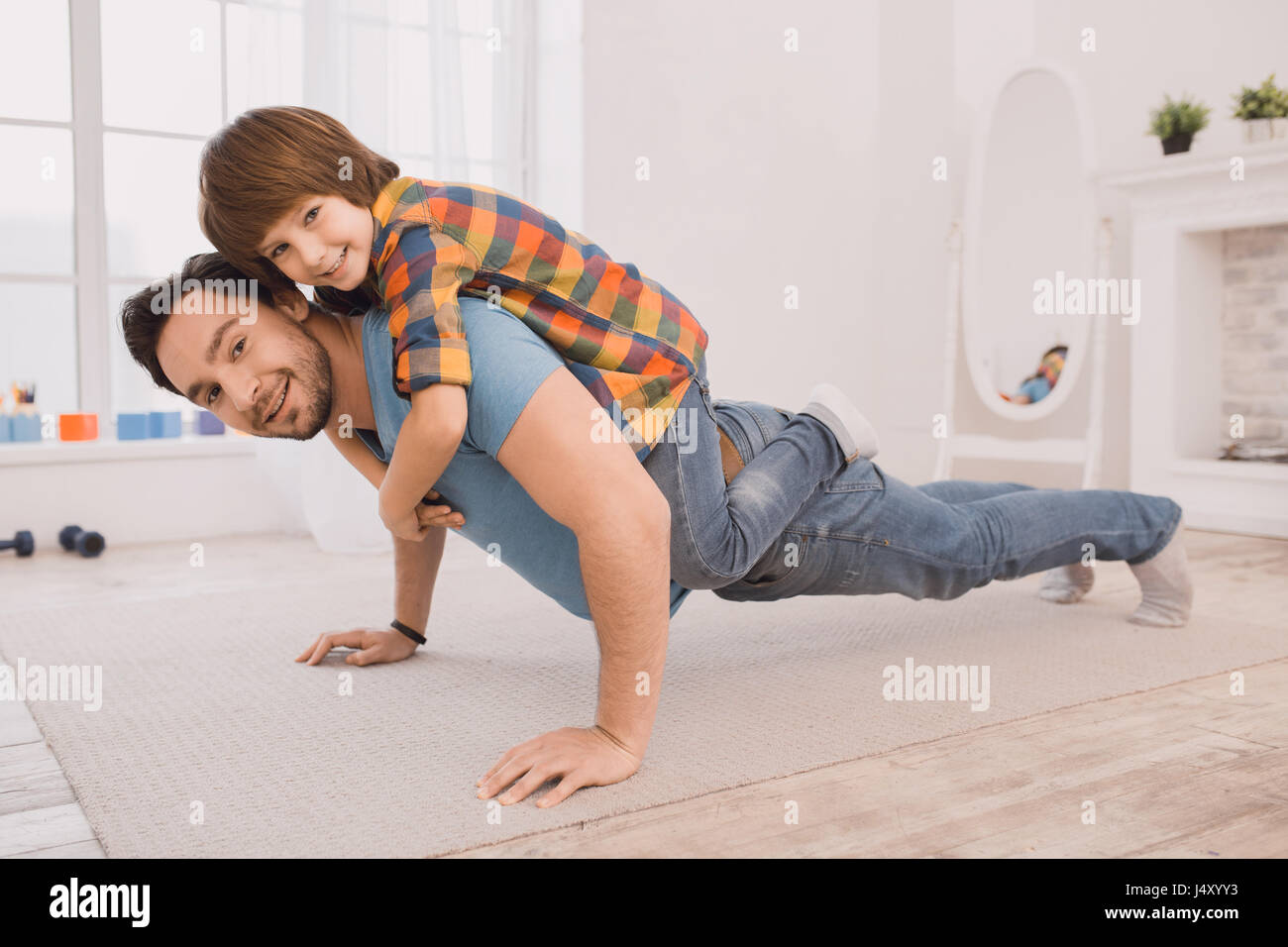 Schoolboy and his family. Физическое воспитание детей. Отец показывает сыну. Покажи как сын занимается. Мама с ребенком школьником.